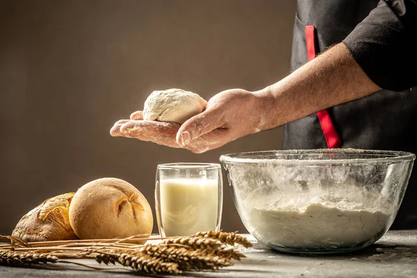 Cooks roll the dough for baking, pieces of raw dough on the wooden Board. Food concept