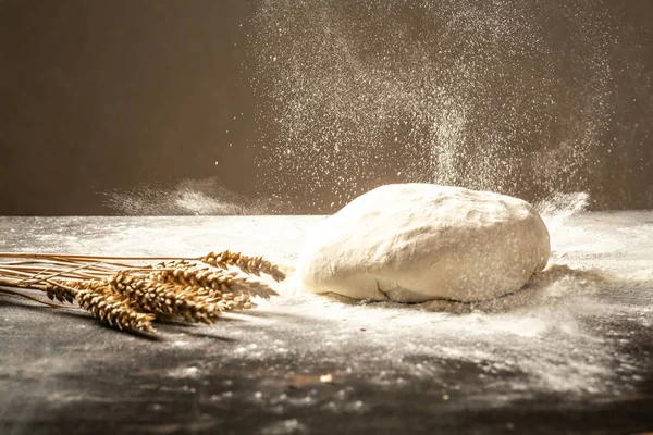 fresh raw dough ball. White flour flying into air. Food concept