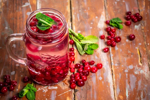 Health care, fitness, healthy nutrition diet concept. refreshing summer drink of berries with mint and ice. infused water, cocktail, detox drink in a glass jar