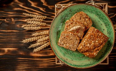 Bir sürü dilimlenmiş ekmek arka planı. Fırın ve bakkal konsepti. Taze, sağlıklı tam tahıl dilimlenmiş çavdar ve rustik ahşap masa çeşitleri, gıda closeup. Ketojenik düşük karbonhidrat diyeti