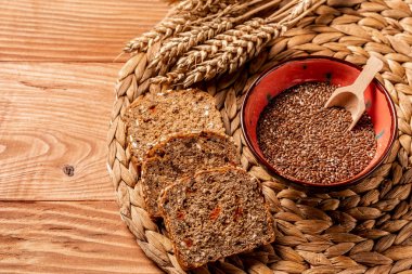 healthy eating concept and weight loss. Sliced rye bread on cutting board. Whole grain rye bread with seeds clipart