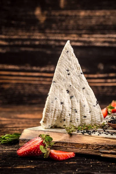 Adyghe cheese with black cumin. cream, cottage cheese on rustic background. space for text — Stock Image Adyghe cheese with black cumin. cream, cottage cheese on rustic background. space for text Stock Photo
