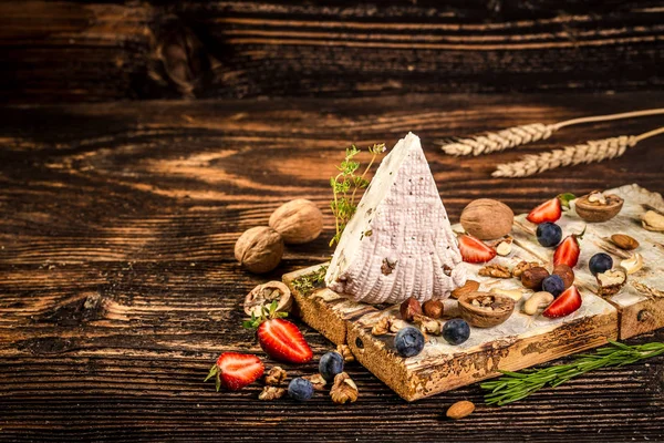 Soft cheese with walnut Adyghe cheese with fresh berries, on rustic background. space for text — Stock Image Soft cheese with walnut Adyghe cheese with fresh berries, on rustic background. space for text Royalty Free Stock Photos