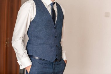 Kendine güvenen, zarif, genç bir adam. Uygun bir adam poz veriyor. Damat giyiniyor ve düğün için hazırlanıyor.