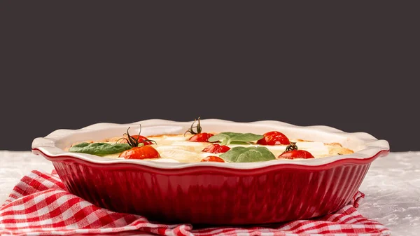 Open pie with spinach and tomato cherry. banner format. space for text.