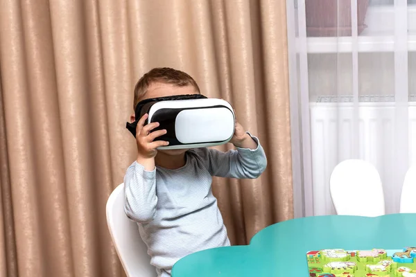 Child with virtual reality goggles dream trip around the world. educational games using modern technology virtual reality glasses.