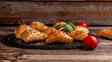 Asian food. Samsa samosas with chicken fillet and cheese on wooden background. Long banner format. Oriental cuisine concept Top view.