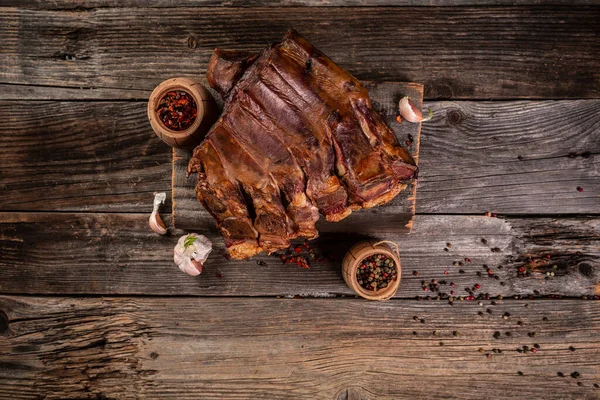 Spicy smoked pork ribs. Barbecue meat. Black background. banner menu recipe place for text. Long banner format.