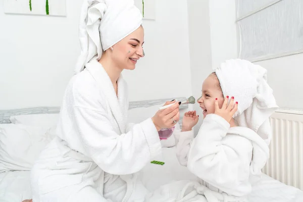 positive Mother and daughter had a day of spa together. mother learning how to be beautiful.