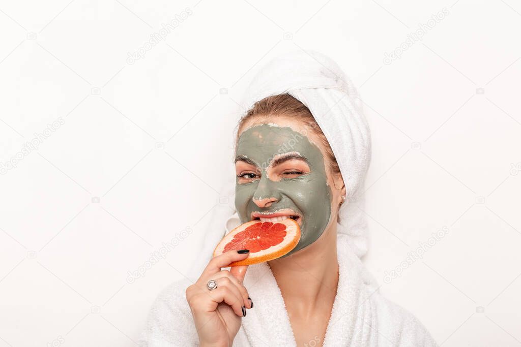 young woman applies natural beauty product on face with grapefruit, uncloges pores, healthy skin.