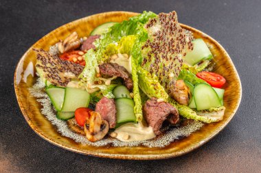 Kızarmış biftekli gurme salatası, taze sebzeler ve kırsal tabakta çıtır çıtır..