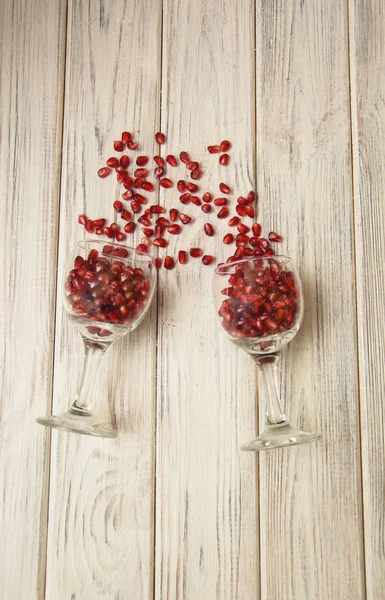 Grains of red pomegranate and whole pomegranate