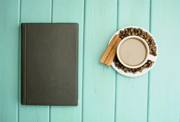 Black coffee beans on a turquoise background