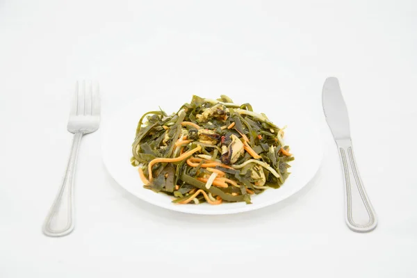 Sea kale in a plate on a white background