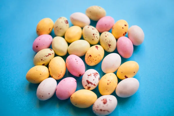 happy easter little yellow white and pink eggs on a blue background