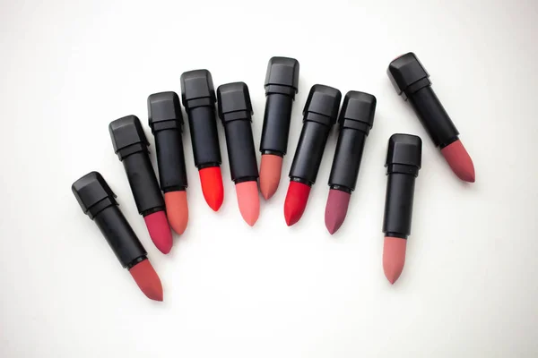 Lipstick in different natural colors on a white background. Top view — Stock Photo, Image