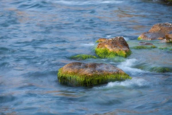 waves rolling on rocks in the sea