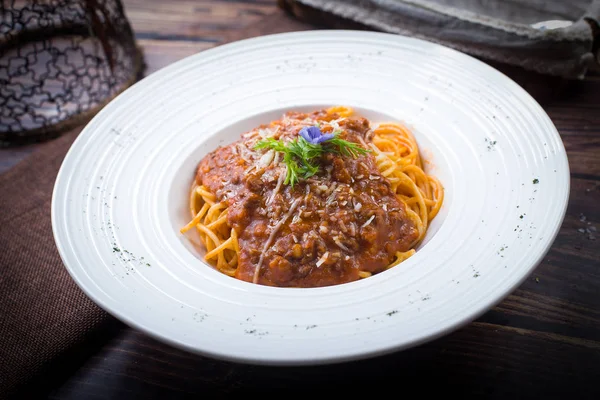 Spaghetti with meat sauce in a white dish