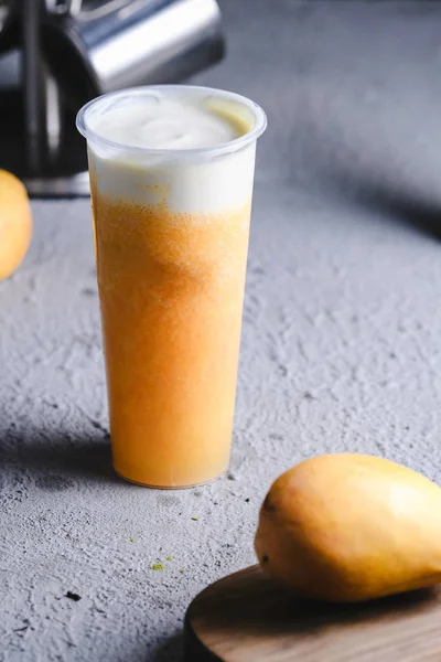 Mango soda covered milk in a clean glass