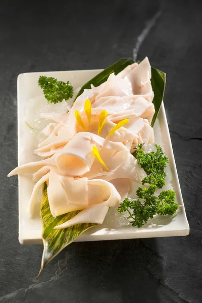 Large blood vessels of fresh pigs and cattle in a white ceramic dish, Hot pot side dish