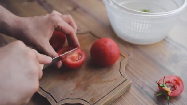 A man washes, cleans and cuts vegetables — Stock Video