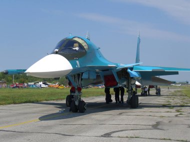 Havaalanı pistinde güçlü bir su-34 uçak Rus askeri avcı Novosibirsk Askeri Havaalanı OKB Chkalov içinde teknisyenler yaz hizmet verilir