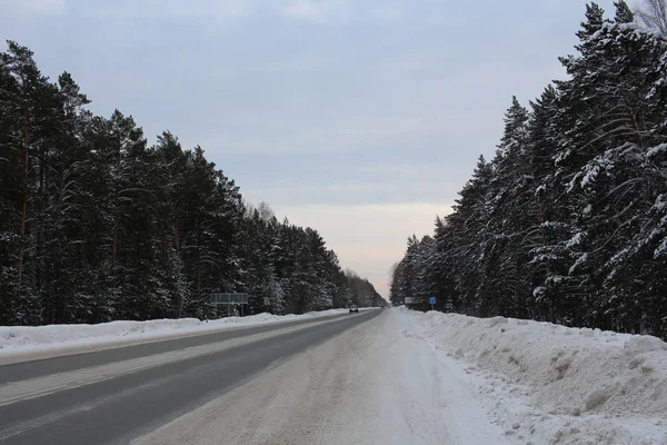winter road wide high-speed road through the forest