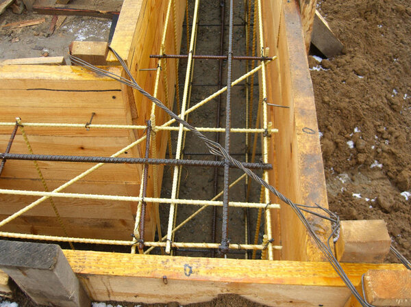 installing wooden forms for pouring the Foundation concrete trench reinforced with reinforcement made of fiberglass