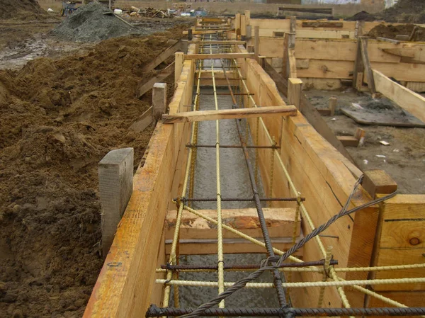 installing wooden forms for pouring the Foundation concrete trench reinforced with reinforcement made of fiberglass