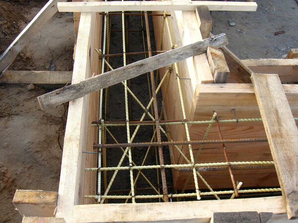 installing wooden forms for pouring the Foundation concrete trench reinforced with reinforcement made of fiberglass