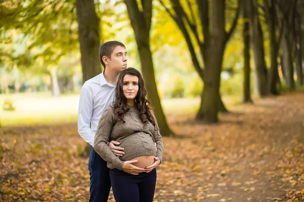 Young Pregnant Couple Hugging Autumn Park — Stock Photo, Image