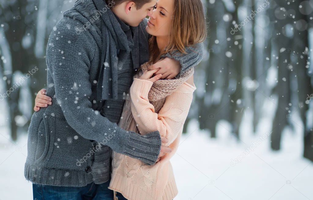 happy young couple having fun in winter park 