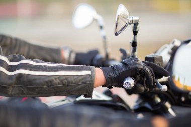 Biker hand rests on the steering wheel motorcycle clipart
