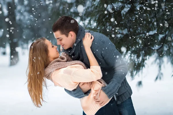 happy young couple having fun in winter park