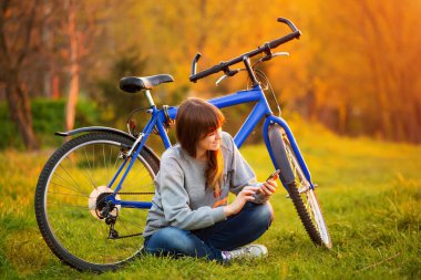 Cep telefonuyla onu bik yanında oturan güzel genç kadın