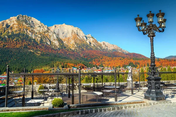 Spectacular restaurant with amazing panorama near Cantacuzino castle, Bucegi mountains in background and colorful autumn landscape, Busteni, Transylvania, Romania, Europe