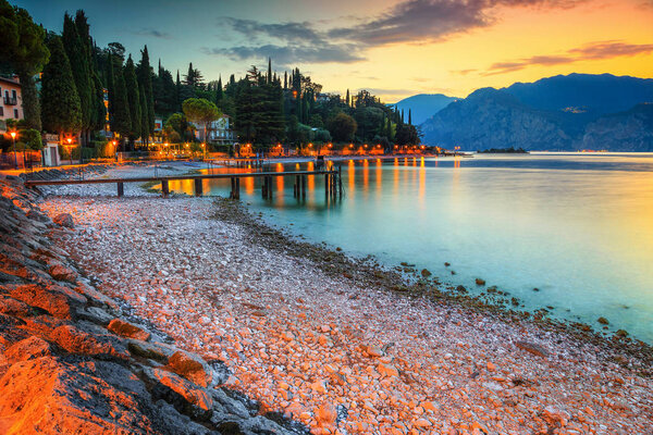 Fabulous place with stunning beach at sunset, Malcesine touristic recreation resort, lake Garda, Veneto region, Italy, Europe