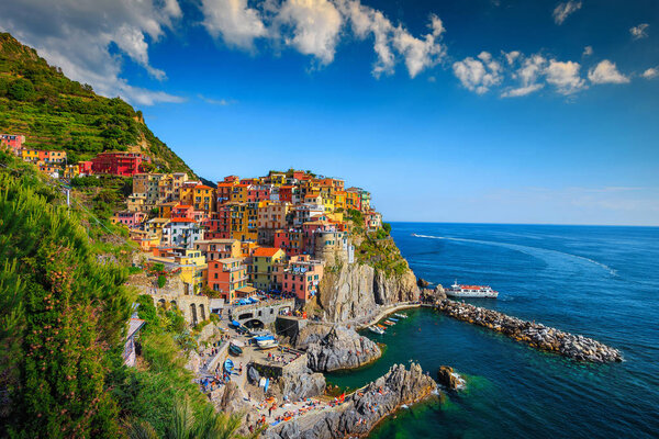 Famous travel destination and photography place, amazing panorama of Manarola touristic village with colorful houses in Cinque Terre National Park, Liguria, Italy, Europe