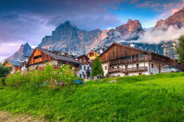 Spectacular summer alpine village in the Dolomites at sunset, Italy clipart