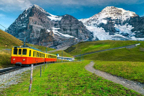 Electric tourist train and snowy Eiger mountain, Bernese Oberland, Switzerland — Stock Photo, Image