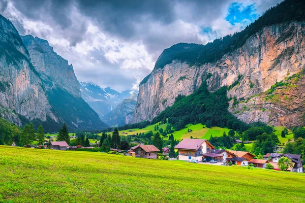 Maravilloso pueblo alpino turístico con campos verdes de verano, Lauterbrunnen, Suiza — Foto de Stock