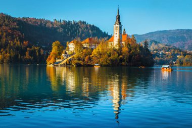 Popular travel and excursion destination at autumn. Amazing lake Bled with picturesque Pilgrimage church on the small island, Bled, Slovenia, Europe clipart