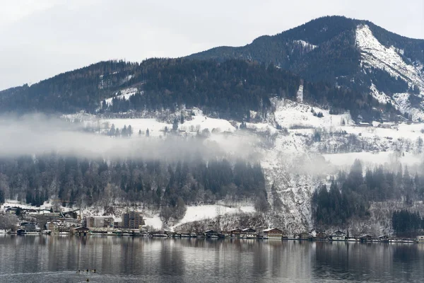 European Alps and Hallstatt lake shore with reflection of mist in Salzburg Flachau Austria.