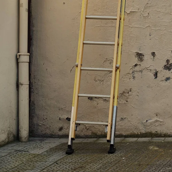 metallic ladder on the wall in the street