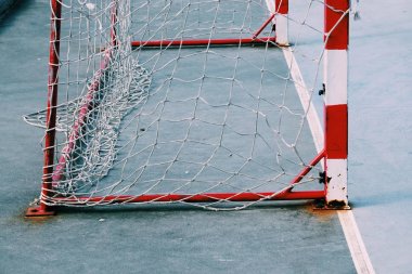  broken soccer goal rope net, old abandoned rope web in the football field