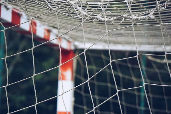 broken soccer goal rope net, old abandoned rope web in the football field