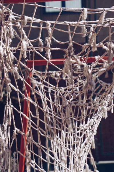 broken soccer goal rope net, old abandoned rope web in the football field