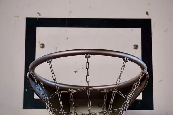 basketball sport hoop with metallic net in the street