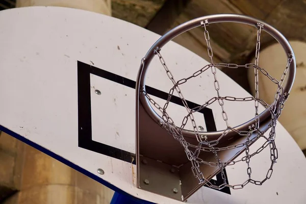 basketball sport hoop with metallic net in the street