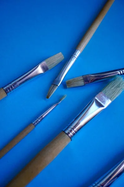 paintbrushes on the blue background, paint set